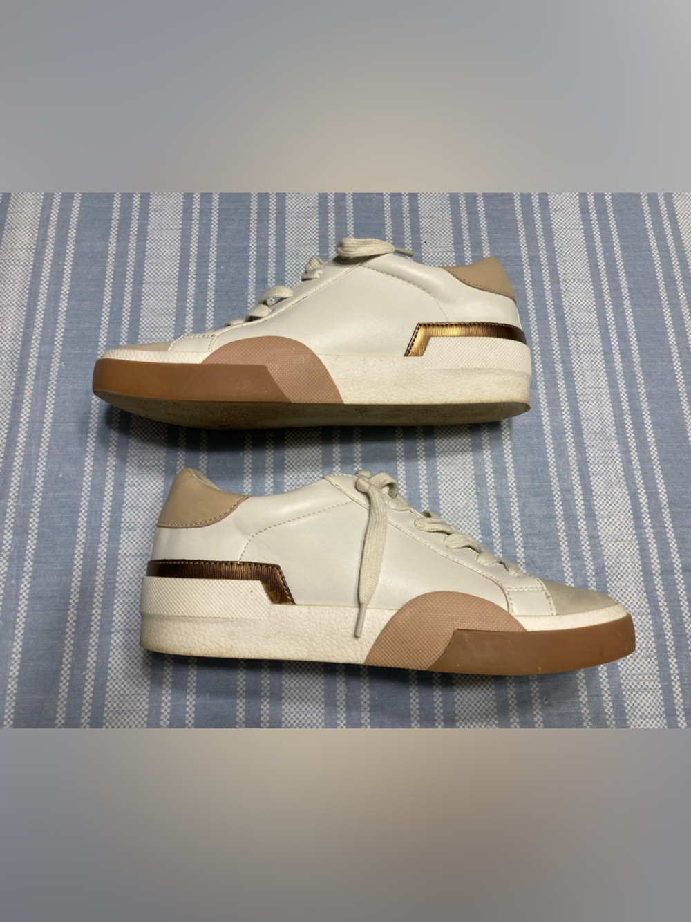 Dolce Vita “Harryson” white, cream, and tan sneakers.
